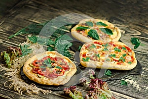 Wariety pizza on wooden board and various ingredients photo