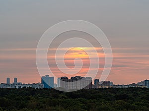 Warm autumn dawn over urban houses and park