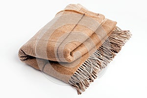 Warm brown alpaca wool or cashmere blanket isolated on white background.