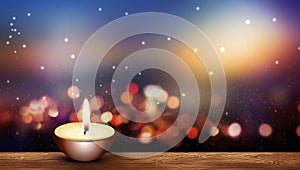 Warm candle on wooden floor bokeh lights background photo