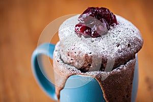 Warm chocolate cake in a mug sprinkled with icing sugar photo