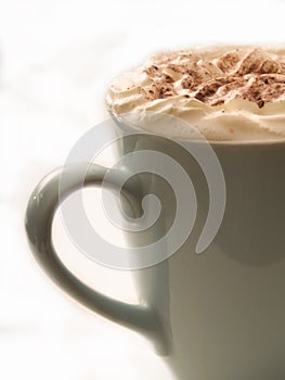 Warm chocolate drink in cup on white