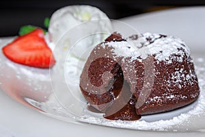 Warm chocolate fondant with a scoop of ice cream and strawberrie