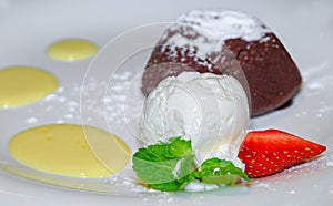 Warm chocolate fondant with a scoop of ice cream and strawberrie