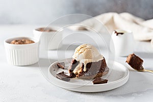 Warm Chocolate Lava Cake with Bite Taken Out of Molten Center and scoop of vanilla ice cream on white background. Restaurant,