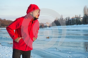 Warm clothes for cold climate. weather forecast. human and nature. man walking snowy landscape in sunset. travel and