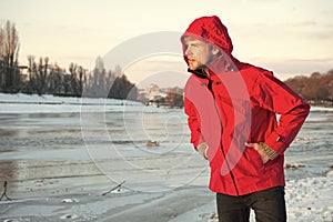 Warm clothes for cold climate. weather forecast. human and nature. man walking snowy landscape in sunset. travel and