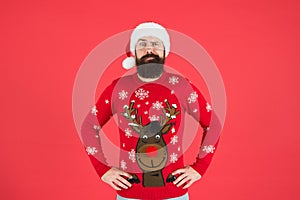 Warm clothes in cold winter weather. holiday season mood. bearded man santa hat red background. merry christmas. ready