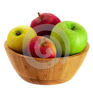 Warm color red, green and yellow apples in a wooden bowl isolated on white background