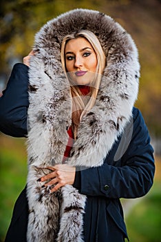 Really warm and cozy. Expensive clothes. Luxury segment brand. Luxury fur. Beauty and fashion. Woman wear coat with huge