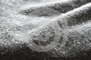 Warm and cozy gray wool blanket texture, wool fabric in grey close-up