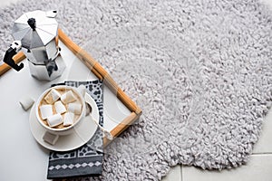 Warm cozy home. Tray and cup of coffee with marshmallows