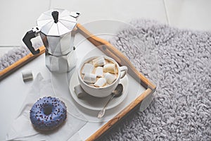 Warm cozy home. Tray and cup of coffee with marshmallows