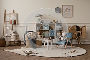 Warm and cozy kids room interior with mock up poster frame, beige wall with stucco, colorful sideboard, braided armchair, plush