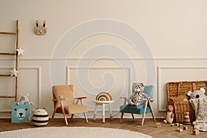 Warm and cozy kids room interior with orange and beige armchair, white stool, round rug, plush toys, wooden blockers, beige wall