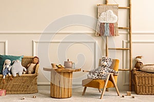 Warm and cozy kids room interior with wooden table, velvet orange armchair, wooden blockers, plush animal toys, wicker basket,