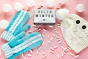 Warm, cozy winter mittens, lightbox on pastel on pink background. Christmas, New Year concept flat lay.