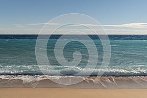 Warm day on a Cannes beach with azure waves of mediterranean sea