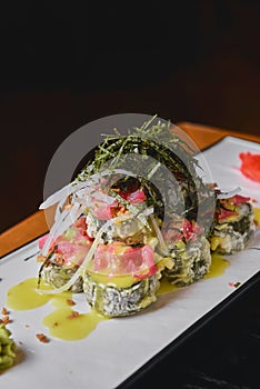 Warm delicious warm sushi with salmon, avocado and nori on the table. Tasty, appetizing and savory Sushi set