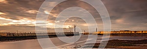 Warm evening sunlight on Whitby Harbour and piers, Yorkshire