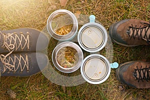 Warm food in a thermos standing on the grass