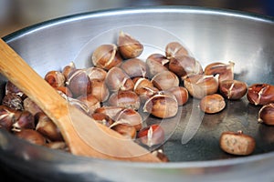 Warm fried edible chestnuts castanea sativa lie in a frying pan