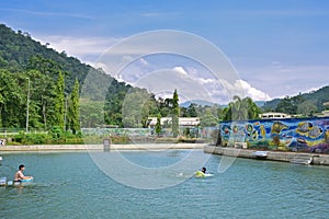 Warm hot spring pond surrounded by artistic colourful mural wall painting at Bentong, Pahang, Malaysia