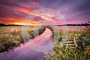 Warm indian summer sunrise over lowland river in vintage colors