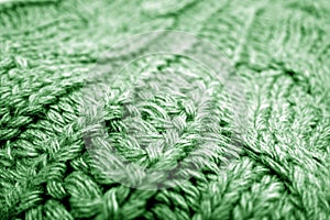 Warm knitting texture with blur effect in green tone