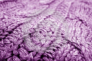 Warm knitting texture with blur effect in purple tone