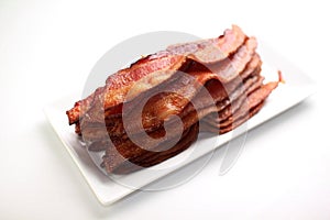 Warm lean bacon on a white plate