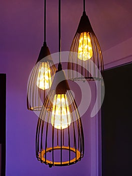 Warm light from beautiful lamps on the ceiling of the bar, against the backdrop of cold lighting from the window on a winter day