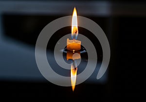 Between the warm light of the flame and the cool, dark background,