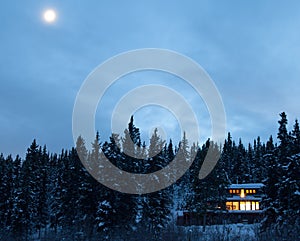 Warm Lights of cozy house in forest Yukon Canada