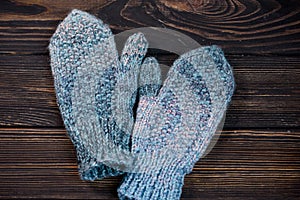 Warm mittens in openwork pattern with a warm scarf. a formula one car on a glossy board