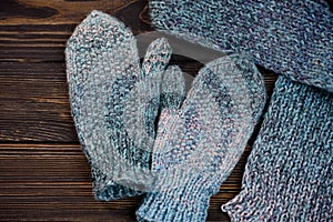 Warm mittens in openwork pattern with a warm scarf. a formula one car on a glossy board