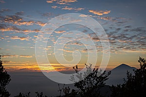 Warm morning sunrise on Ghober Hut campsite with view of mount Cikuray. Beautiful landscape of mount Papandayan. Papandayan