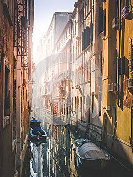 Warm morning in venice, sun approaching the narrow water channel