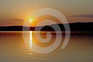 Warm orange sunset sky over Montargil lake, Portugal