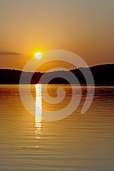 Warm orange sunset sky over Montargil lake, Portugal