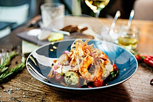 Warm salad with Argentinian king prawns. Almond potato, mini romaine lettuce, carrot, cherry tomato, pesto, black root