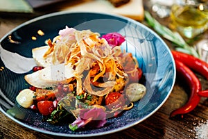 Warm salad with chicken. Almond potato, mini romaine lettuce, carrot, cherry tomato, pesto, black root chips