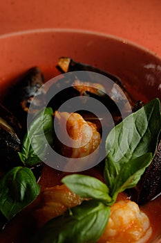 Warm salad of grilled fish slices, shrimp and mussels