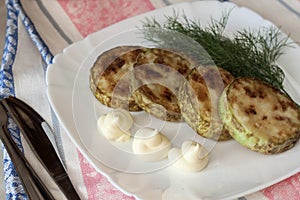 Fried marrows with mayonnaise on a plate