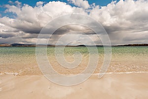 Warm sandy beach of Gurteen bay, county Galway, Ireland. Warm sunny day. Cloudy sky. Irish nature landscape