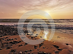 Warm seascape,summer,sun and Baltic sea with sand and small rocks.