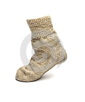 Warm sock made of natural sheep wool on a white background