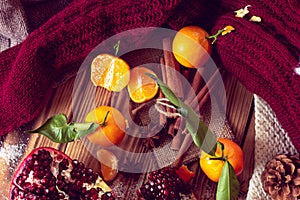 Warm still life with tangerines and pomegranate