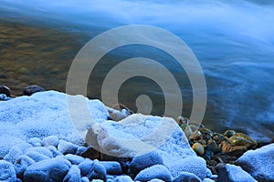 Warm stones beside cold clean creek water