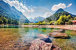 A warm summer day, many tourists rest on the shore of the Jasna lake. Wonderful summer scene of Julian Alps, Gozd Martuljek locati